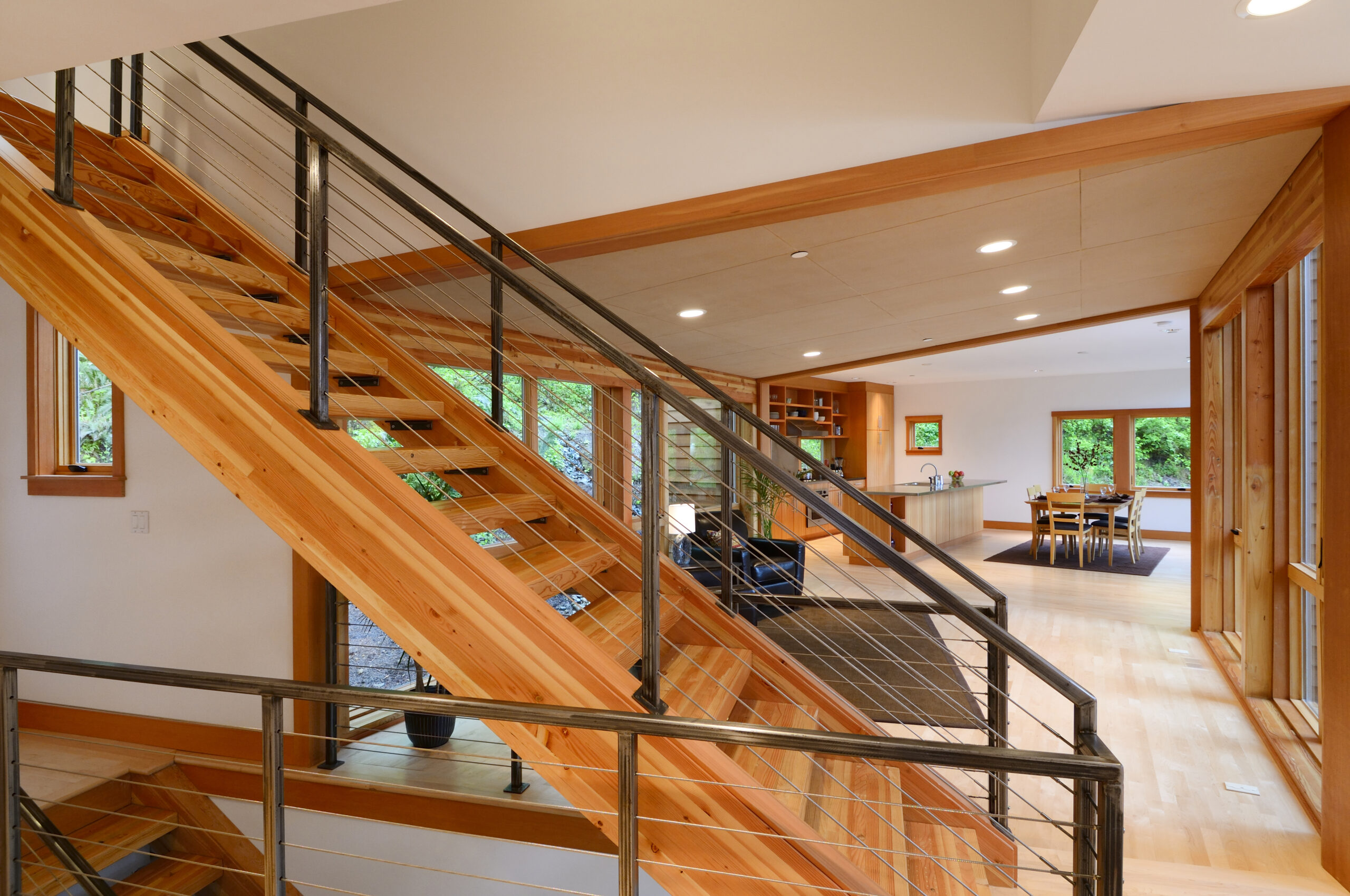 Wooden staircase with cable railing in modern home design