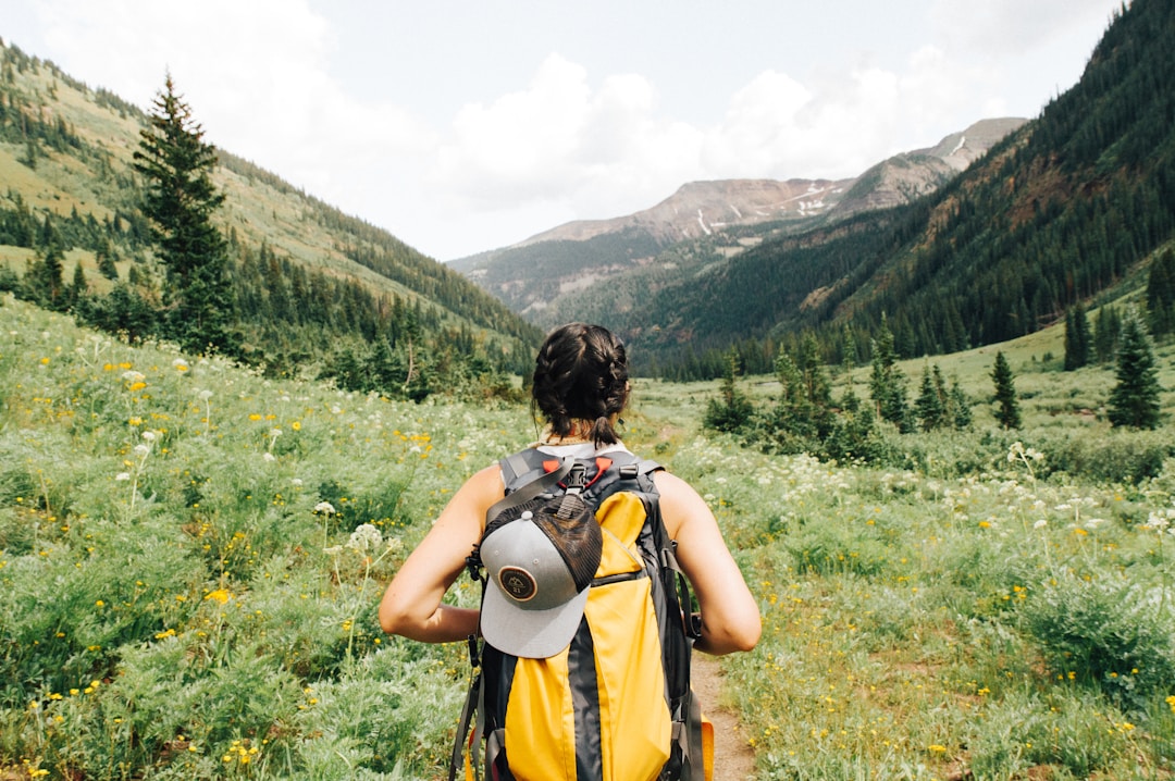 Person hiking in mountains and valleys, connecting with nature.