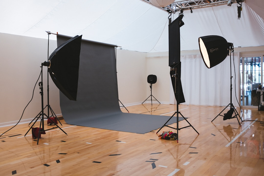 Professional photography studio setup with lighting equipment and backdrop.