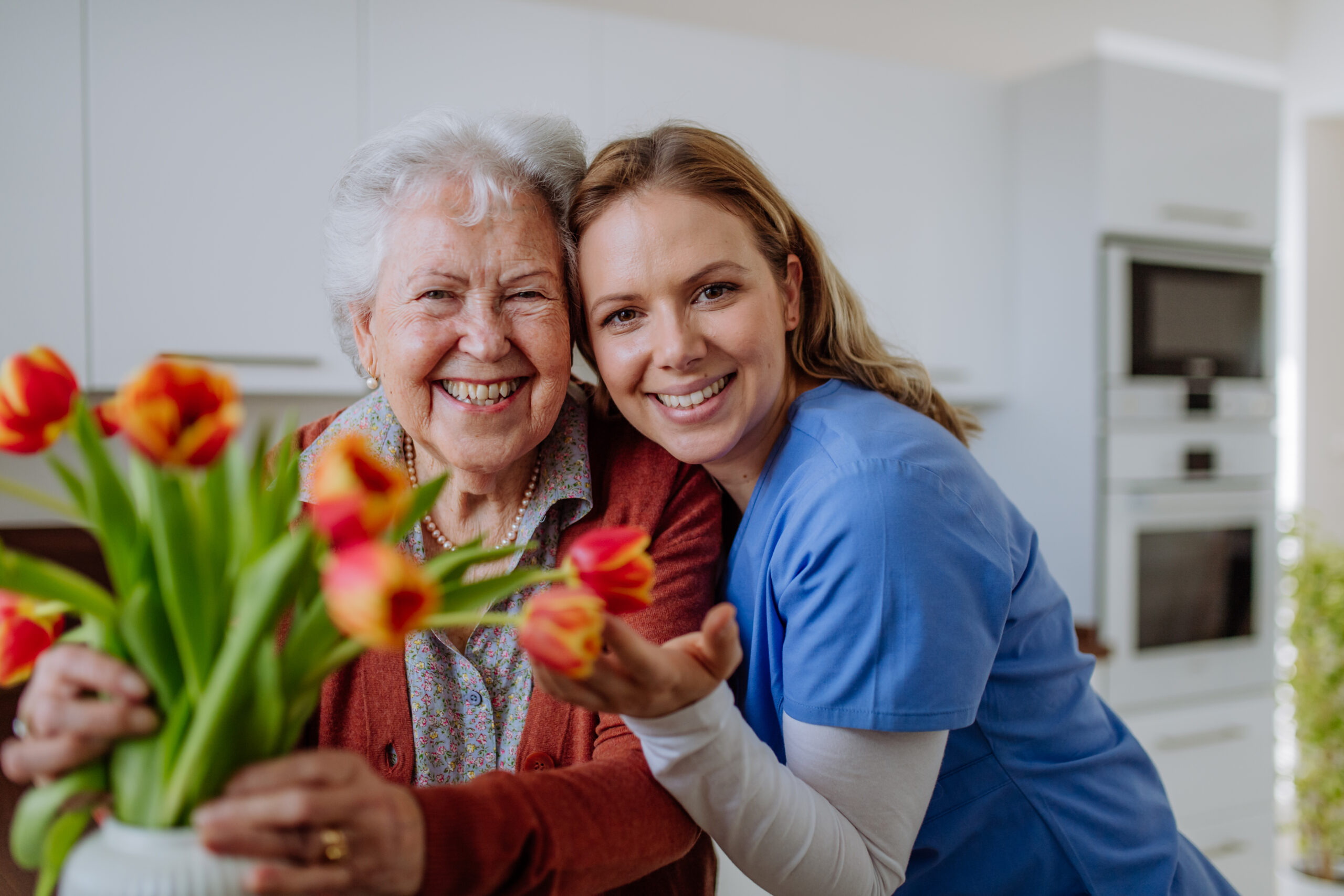 Senior woman and nurse with tulip bouquet, travel healthcare career illustration.