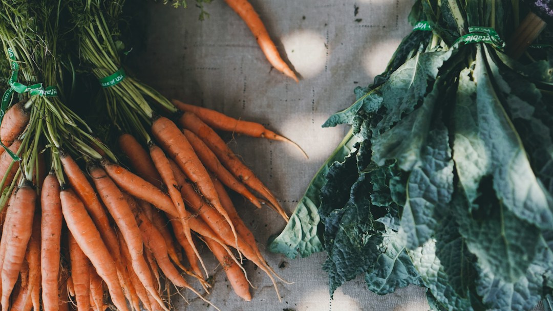 Fresh carrots and kale, natural food choices from farmer's market.