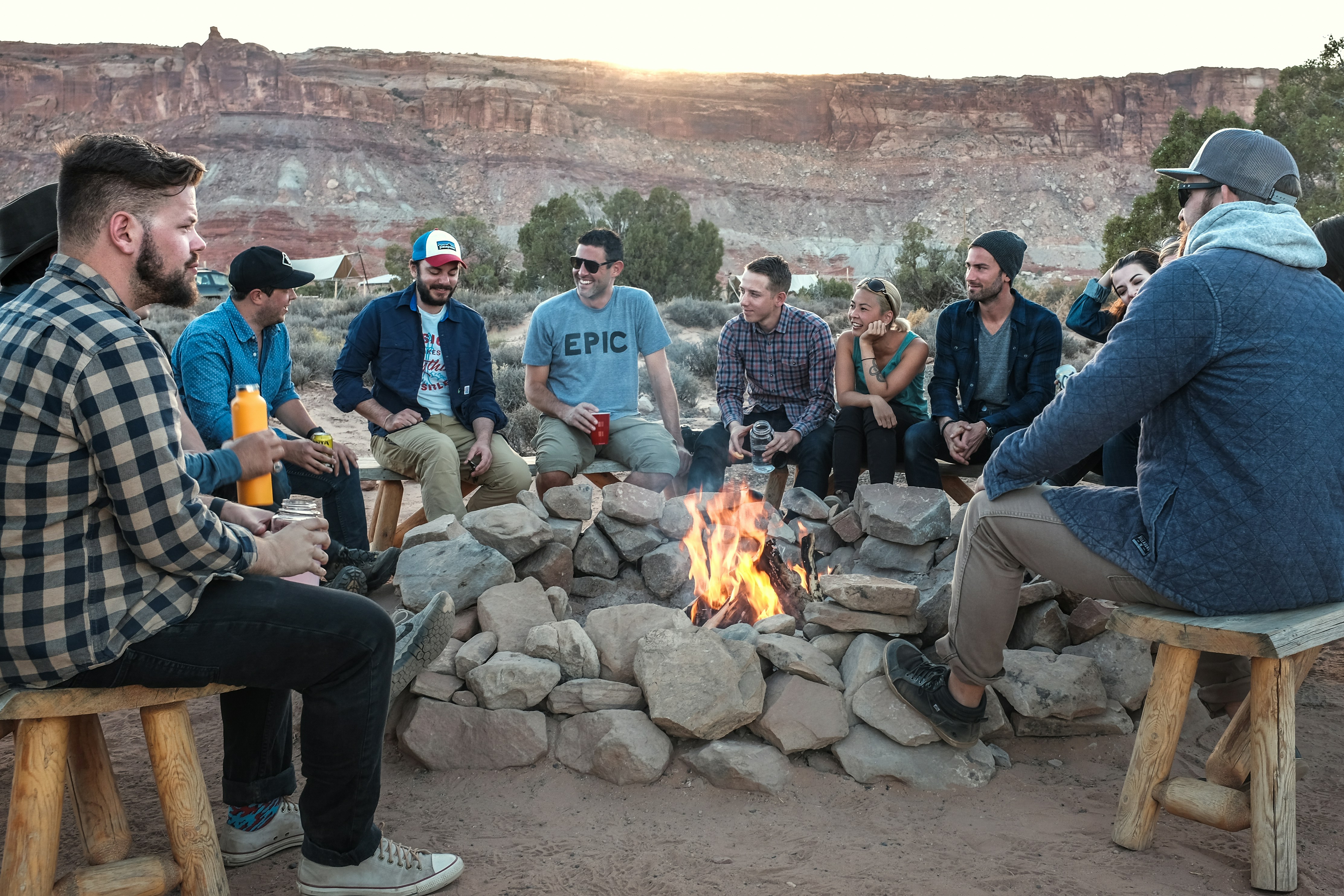 Group of friends gathering around a campfire finding joy and new connections.