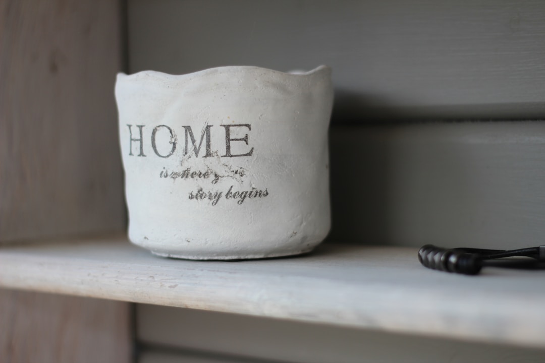 Concrete planter with "Home is where the story begins" illustrating homeowner protection and warranty plans.