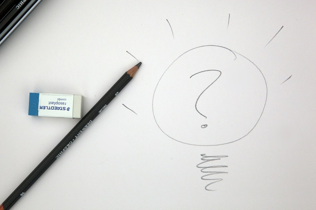 Sketch of a lightbulb with a question mark, pencil, and eraser representing restaurant concept development.