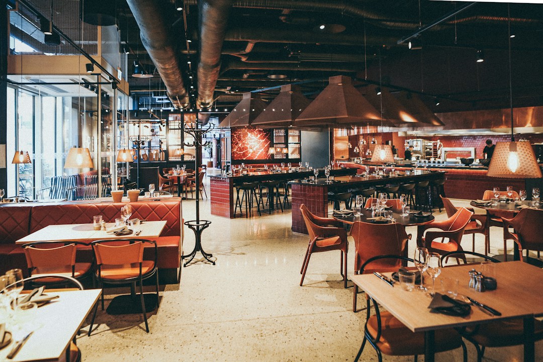 Restaurant interior showcasing dining area and open kitchen design.