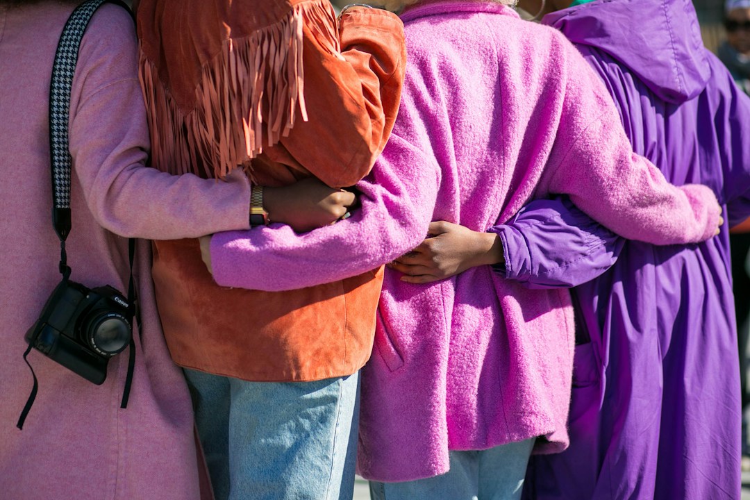 People embracing, demonstrating teamwork and community outreach for a political campaign.