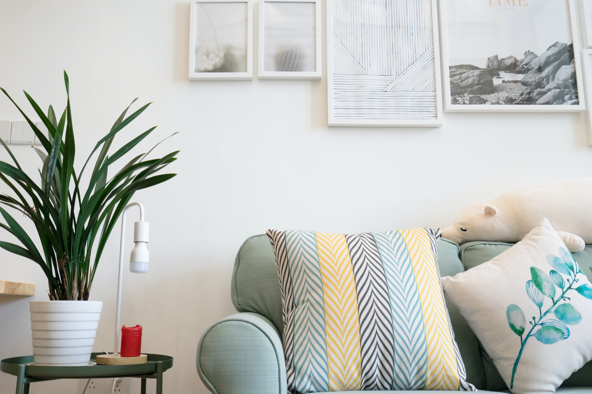 Decluttered living space with decorative pillows and framed art, illustrating home organization tips.