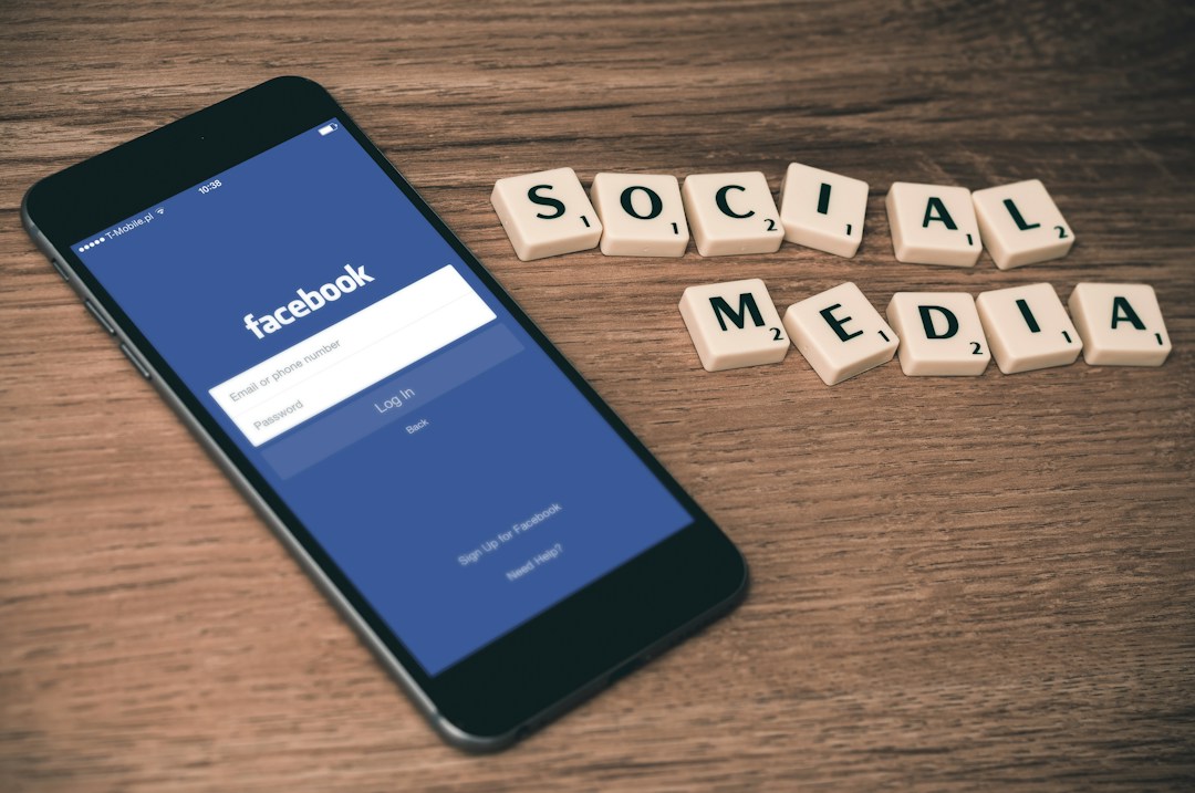 Smartphone displaying Facebook login screen and social media letter blocks