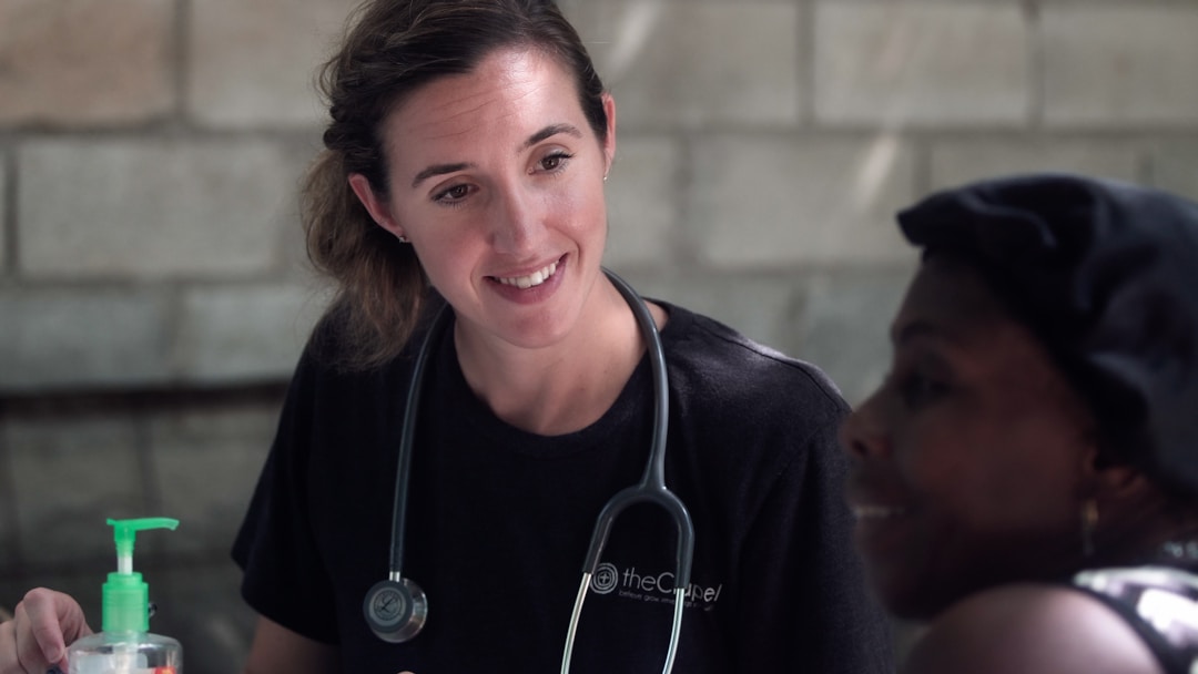 Healthcare professional smiling and interacting with a patient, demonstrating adaptability and cultural competence.
