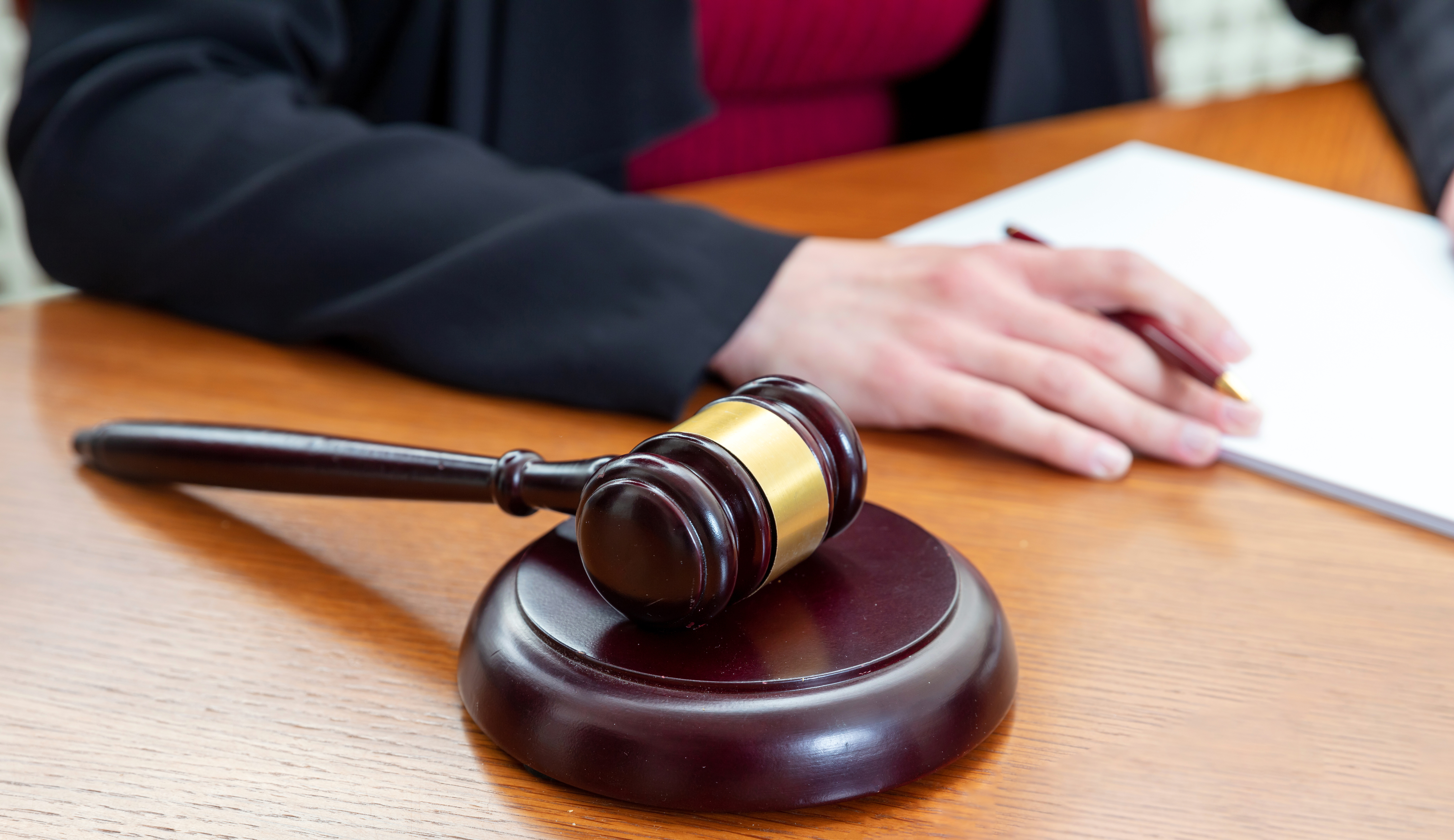 Judge’s gavel and notepad illustrating legal guidance after a criminal charge.