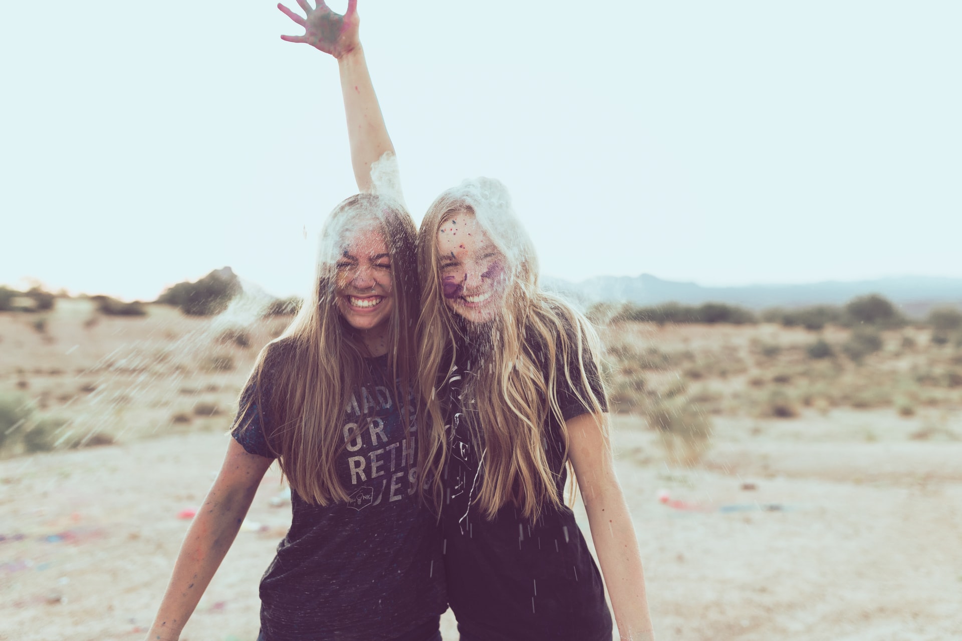 Two smiling women with flour-covered faces celebrating new beginnings and personal growth.
