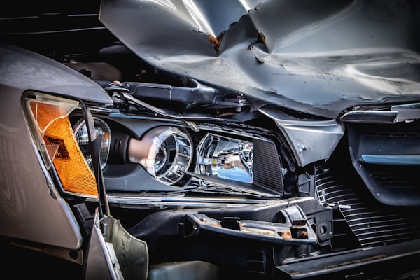 Damaged car front illustrating aftermath of a car accident and vehicle repair.