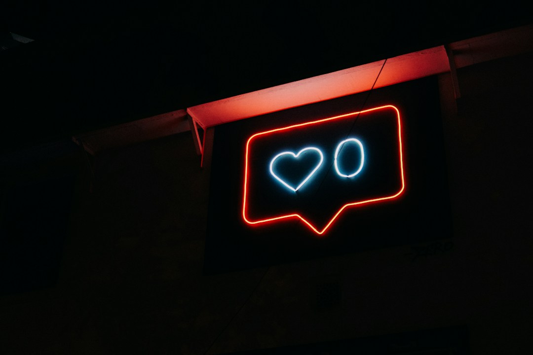 Neon heart and like symbol representing social media engagement and online presence.