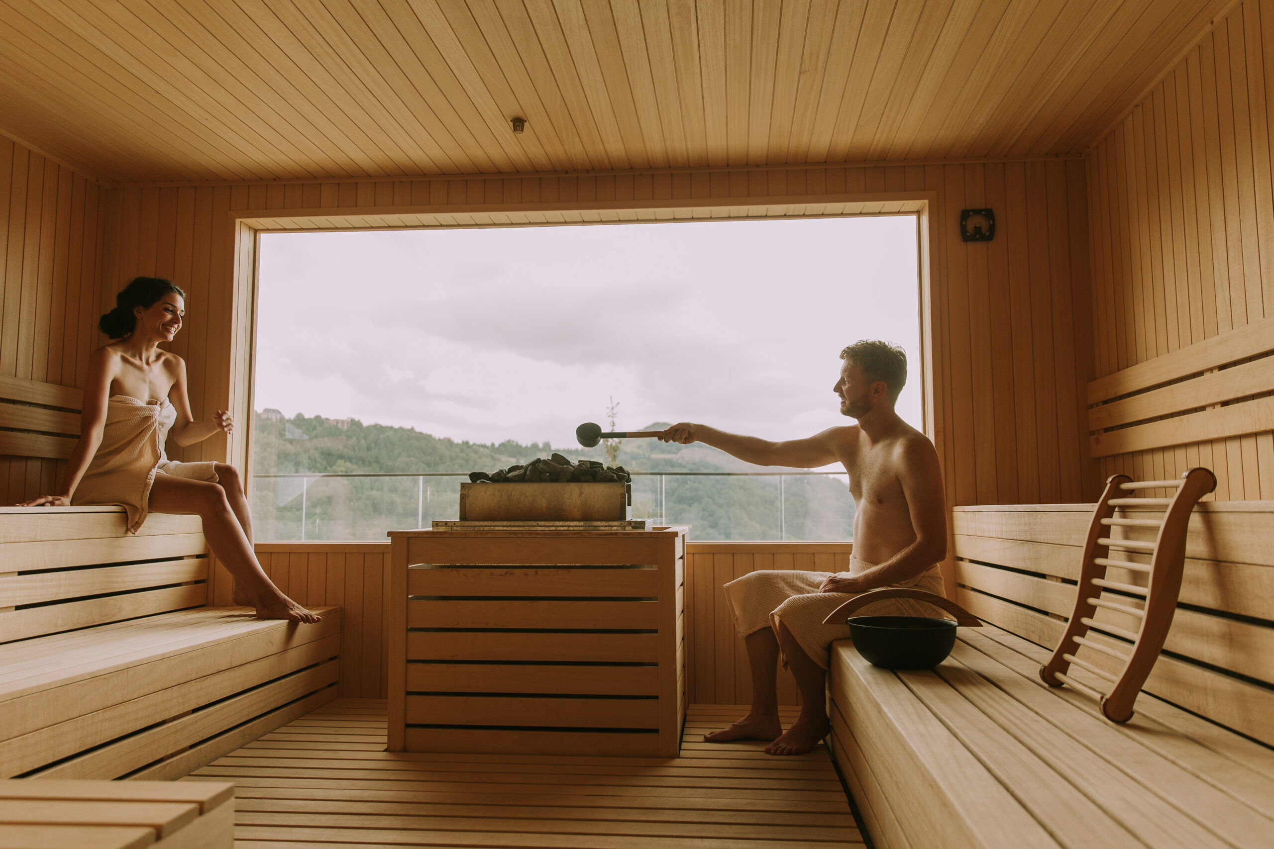 Young couple relaxing in sauna promoting selfcare and stress relief.